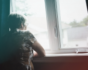 Older woman looking out the window