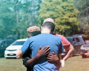 Ira hugging his son before drop-off at summer camp.