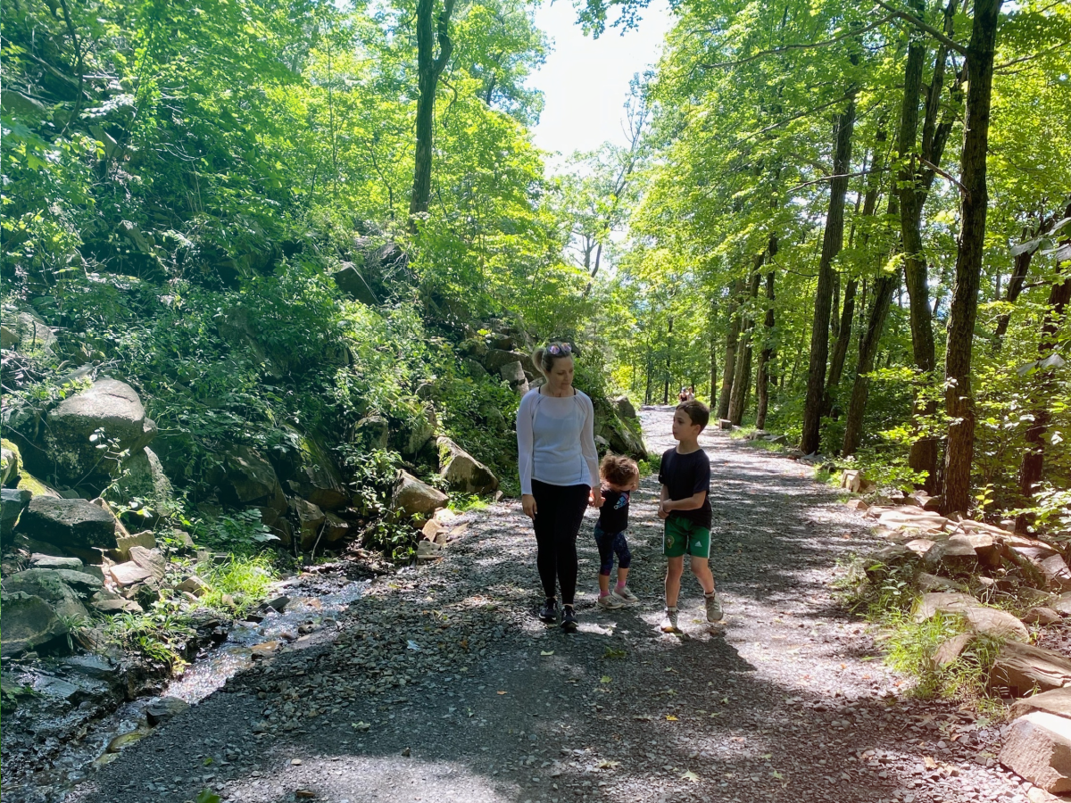 Jenn Hoos Rothberg walking with her children in a park.