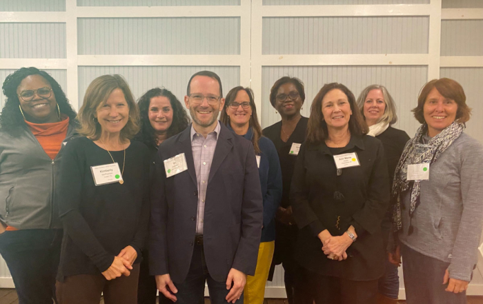 a group of people standing and smiling