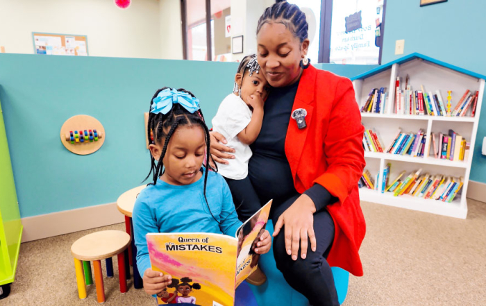 Mother and daughters reading